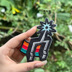 A 3 by 3 inch custom embroidered star patch styled on a black canvas streetwear backpack.