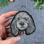 Front view of a 3x3 inch iron-on dog patch with realistic black and white premium embroidery.