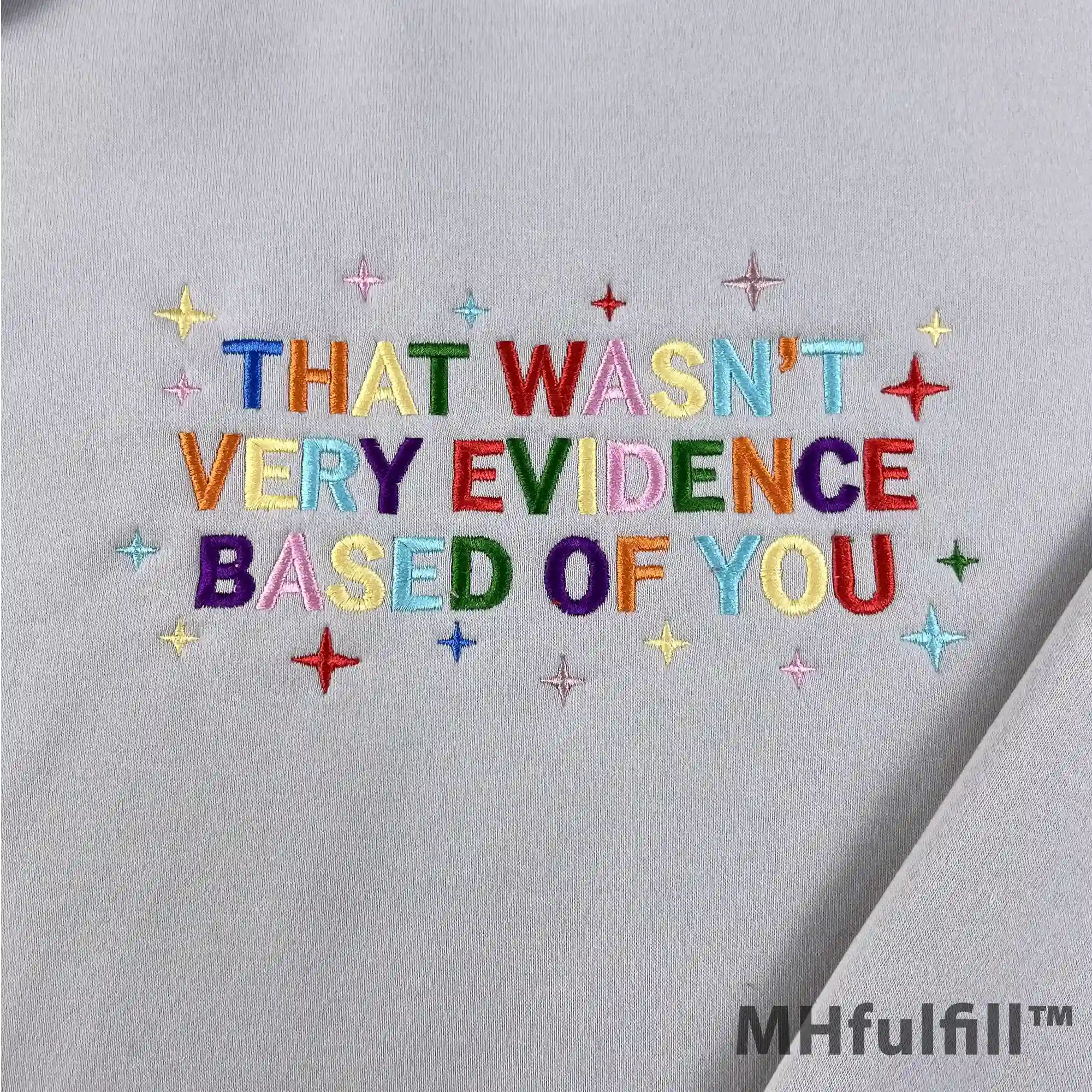 Flat lay of a funny academic gift embroidered pullover sweatshirt for science and data lovers.