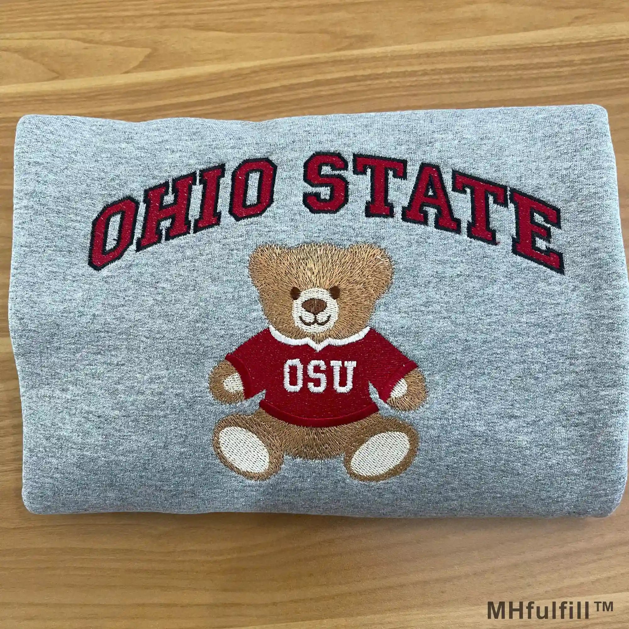 Teenager wearing an oversized custom college teddy bear embroidered crewneck for a vintage school look
