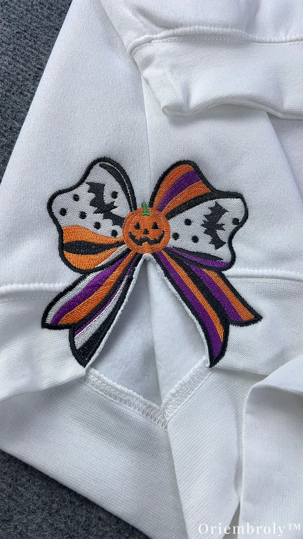 Embroidered Halloween bow featuring bats and pumpkin center