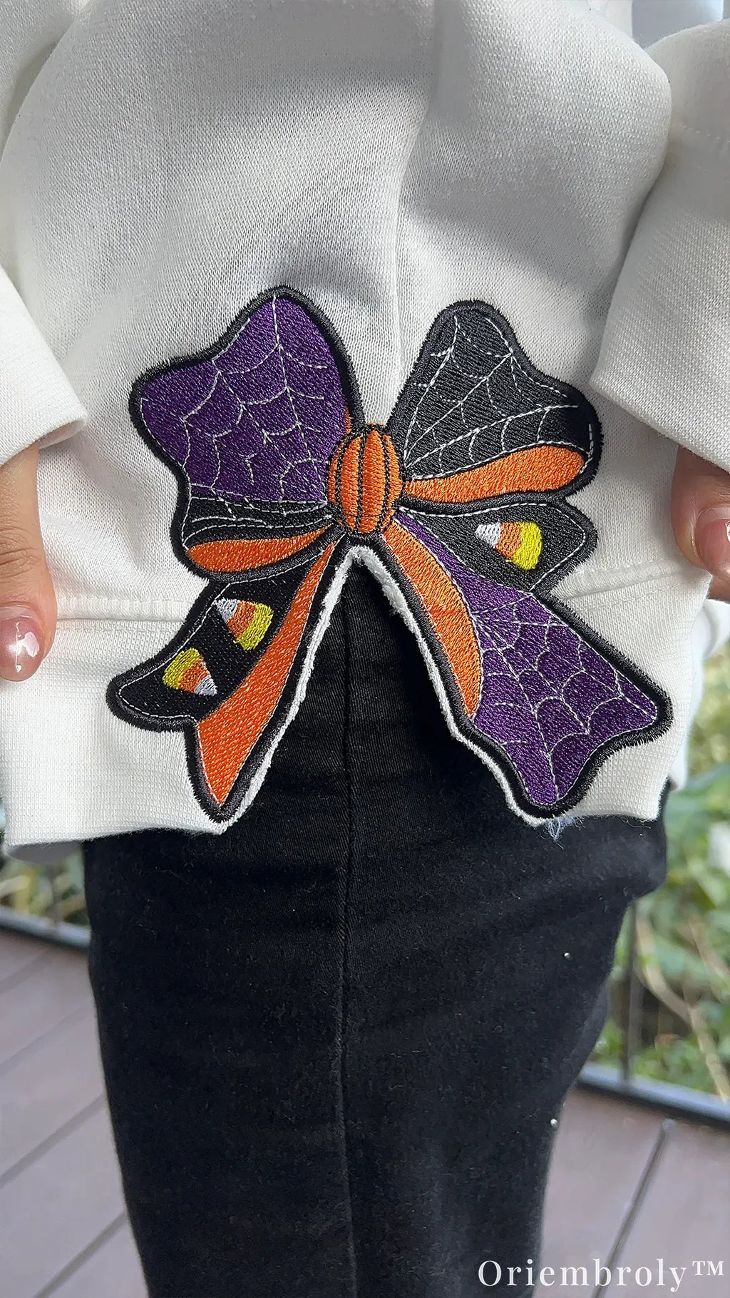 Embroidered sleeve bow with candy corn and spiderweb details