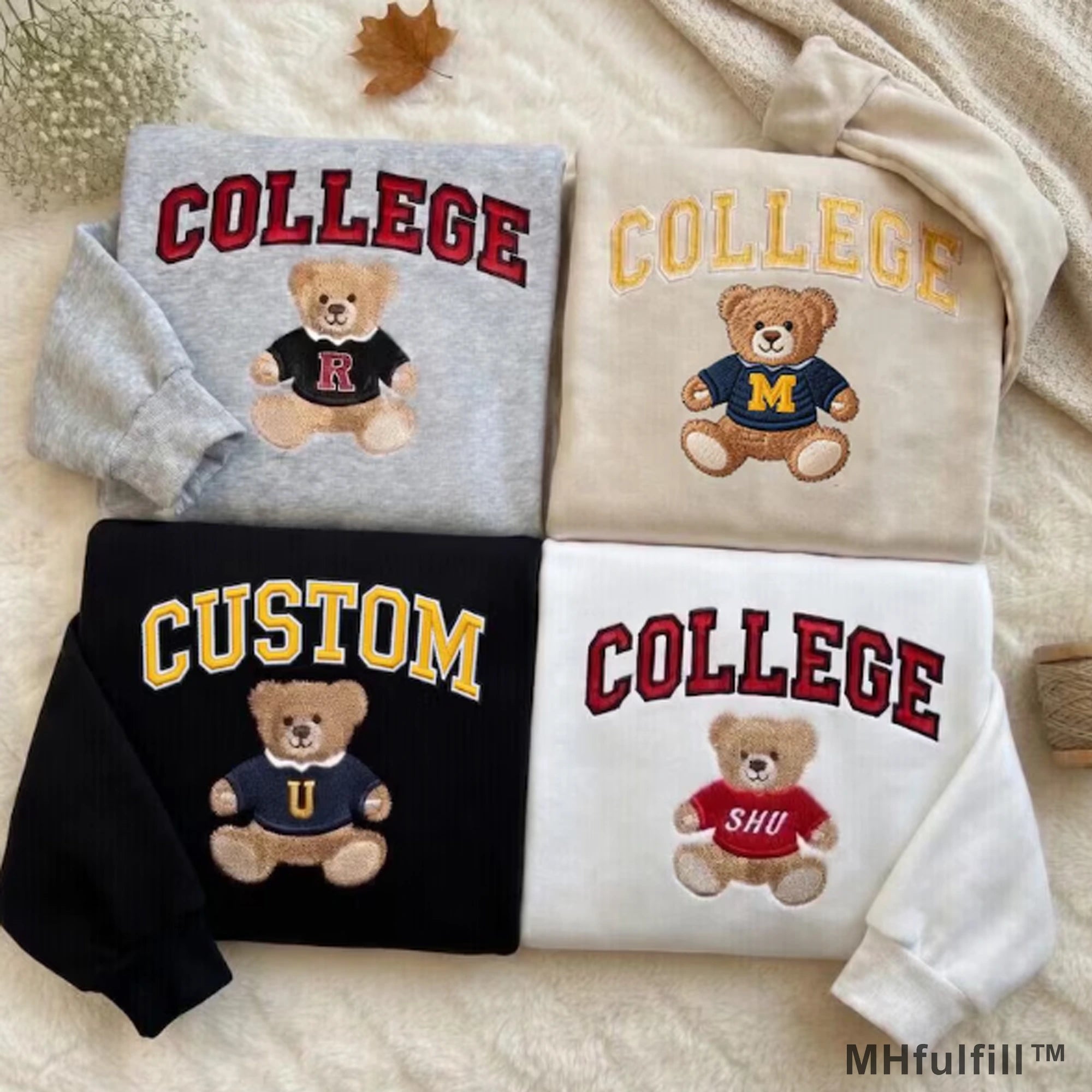 Four colorful custom college teddy bear embroidered sweatshirts flatlay by MHfulfill