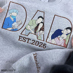Detailed view of premium satin stitch embroidery showing a father hugging his baby on a personalized custom sweatshirt.