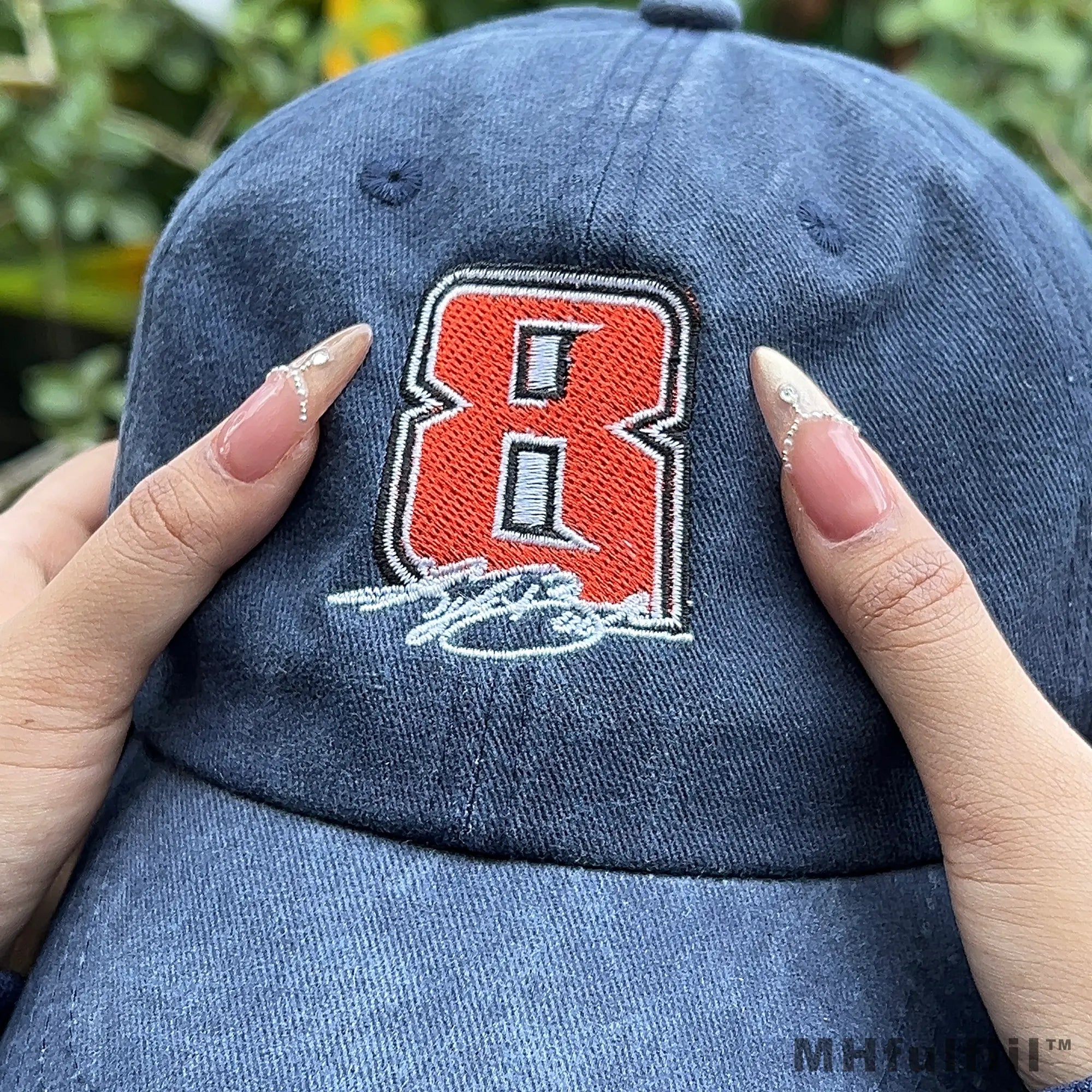 Young man wearing a vintage custom embroidered hat in a casual urban streetwear style.