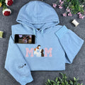 Custom embroidered MOM sweatshirt in light blue featuring a mother and baby portrait design inside the lettering.