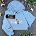 Custom embroidered MOM sweatshirt in light blue featuring a mother and baby portrait design inside the lettering.