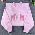 Custom Mom line art embroidered sweatshirt in pastel pink color featuring glitter applique lettering.