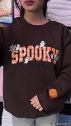 Embroidered ghost, bat, and spiderweb details on Halloween sweatshirt