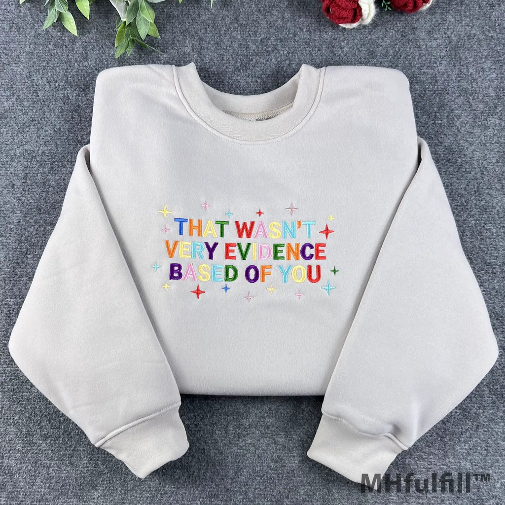 Front view of a premium embroidered science meme crewneck with rainbow letters and star sparkles details.
