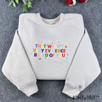 Front view of a premium embroidered science meme crewneck with rainbow letters and star sparkles details.