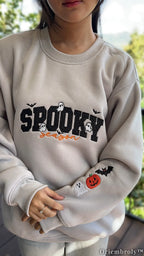 Embroidered ghost bat and pumpkin Halloween sweatshirt with model wearing