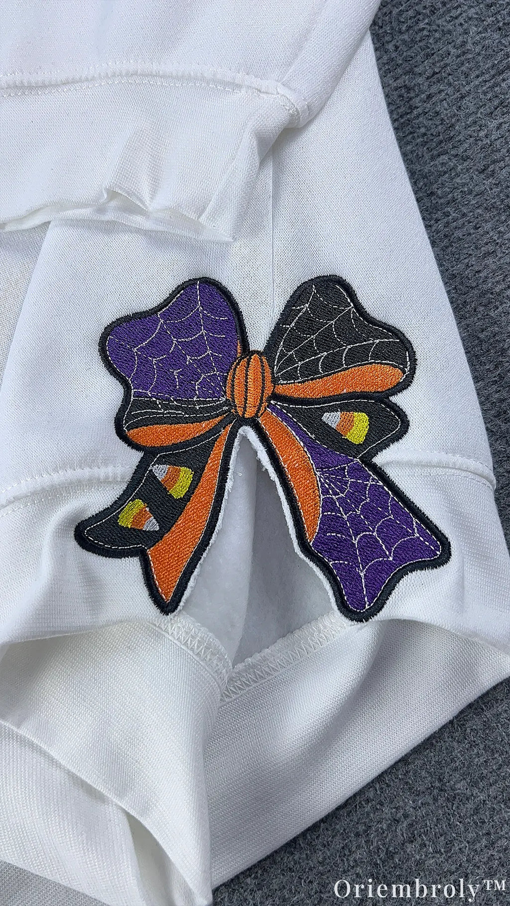 Halloween embroidered ribbon bow on sweatshirt sleeve