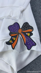 Halloween embroidered ribbon bow on sweatshirt sleeve