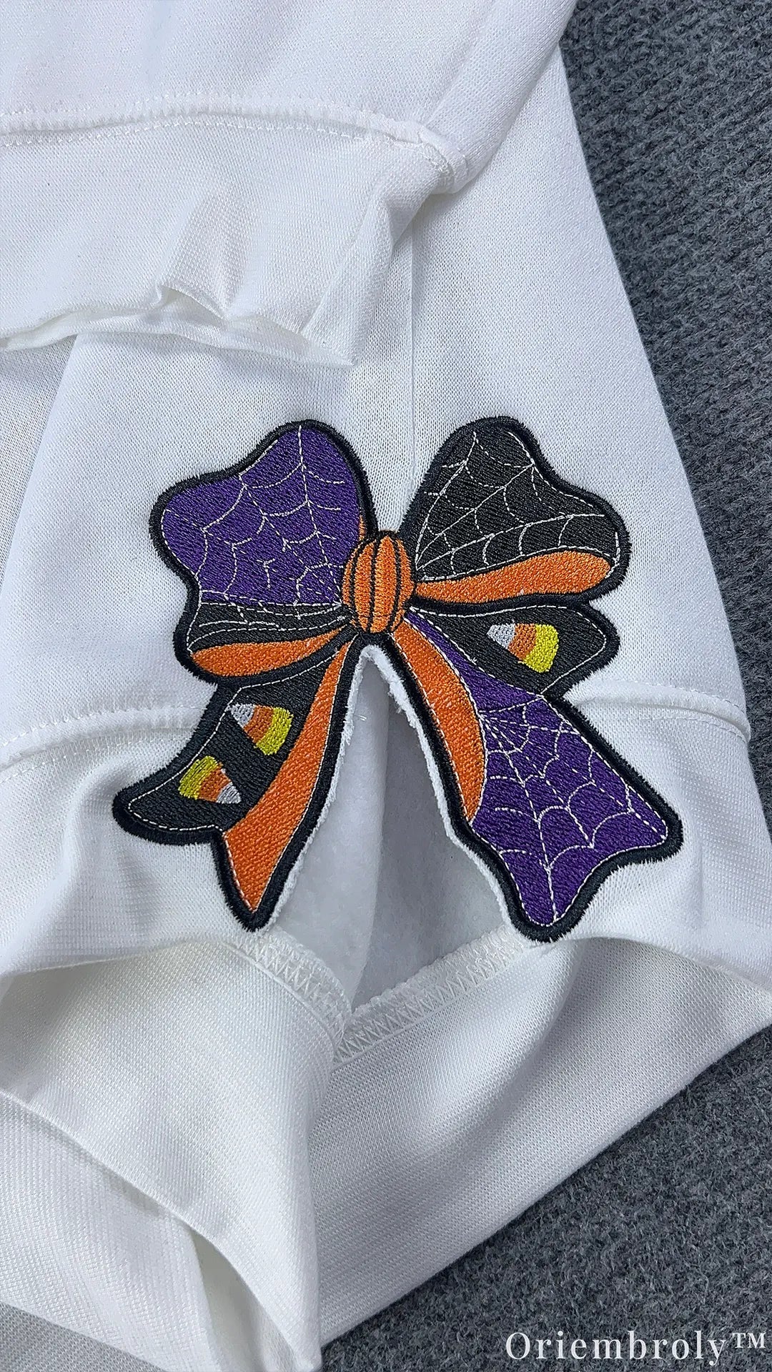 Halloween embroidered ribbon bow on sweatshirt sleeve