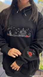 Halloween Village embroidered sweatshirt with witch and haunted house design with model wearing