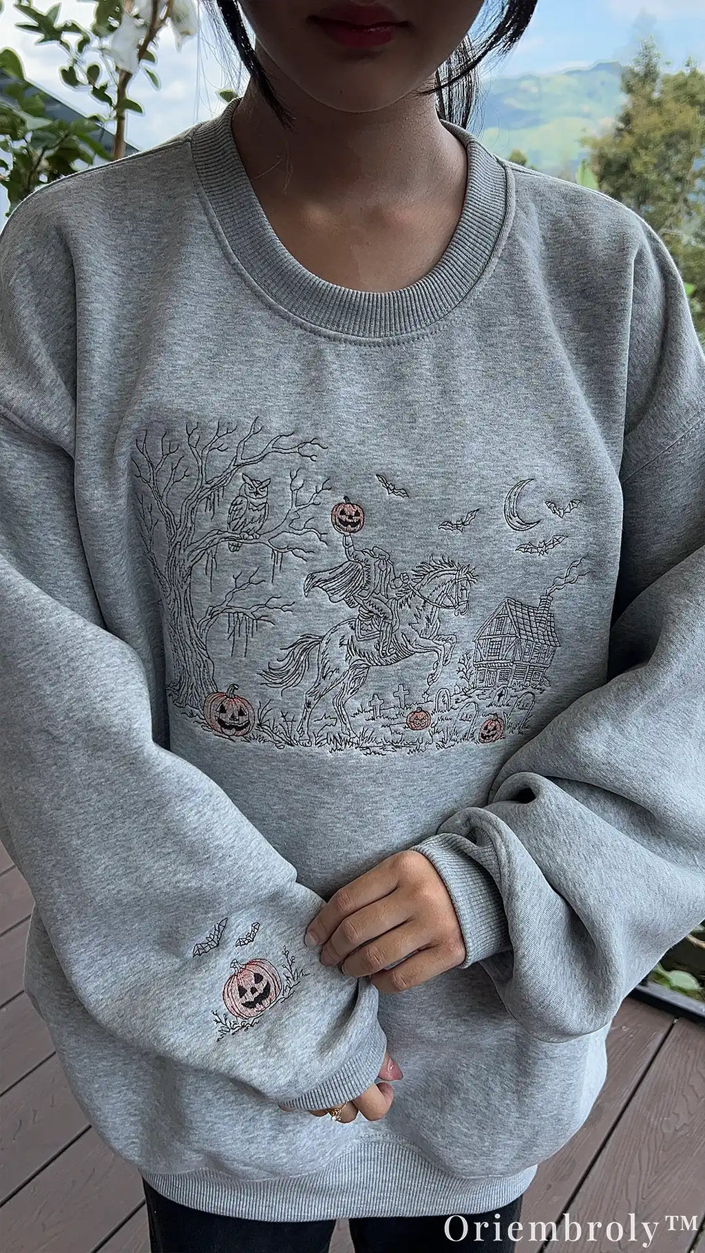 Embroidered haunted landscape with graveyard, bats, and moon