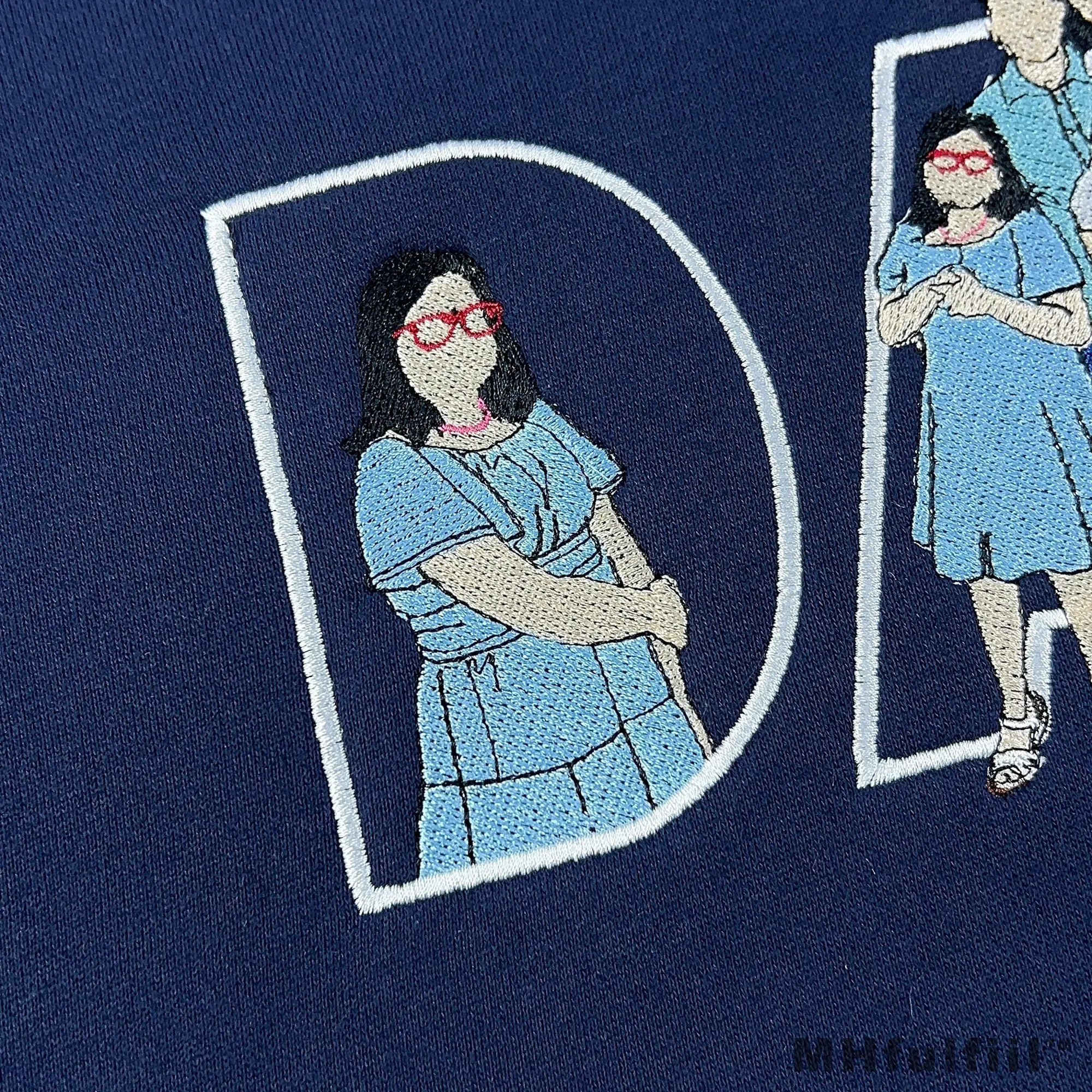 Close-up of premium custom embroidered portrait lines inside DAD lettering on a sweatshirt by MHfulfill.