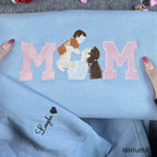 Detailed view of a custom motherhood portrait stitched inside pink varsity letters on a cozy sweatshirt.