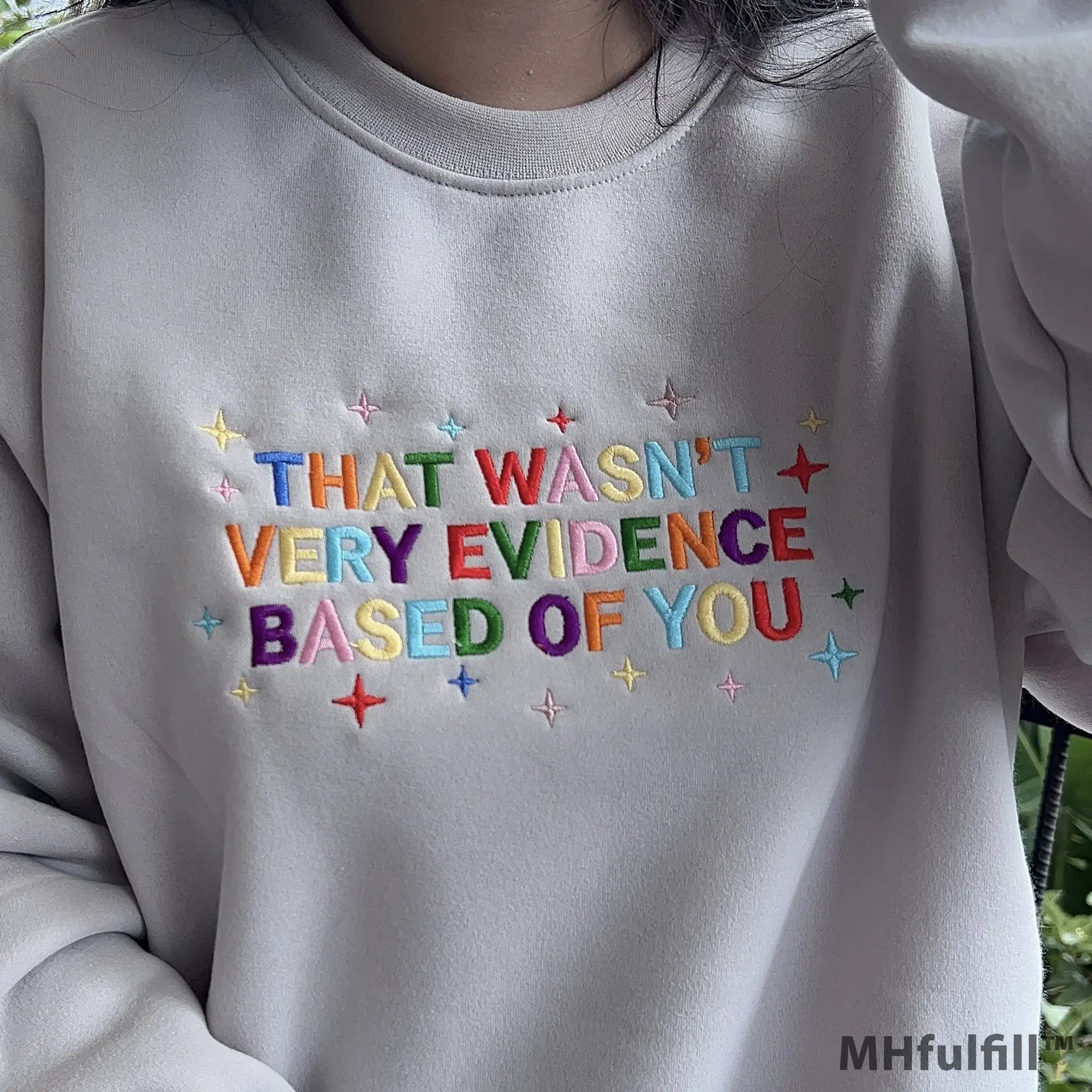 Model wearing an oversized custom embroidered evidence based sweatshirt in a streetwear style.