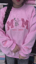 Detail of MOM text with pink glitter applique and EST 2006 custom embroidery.