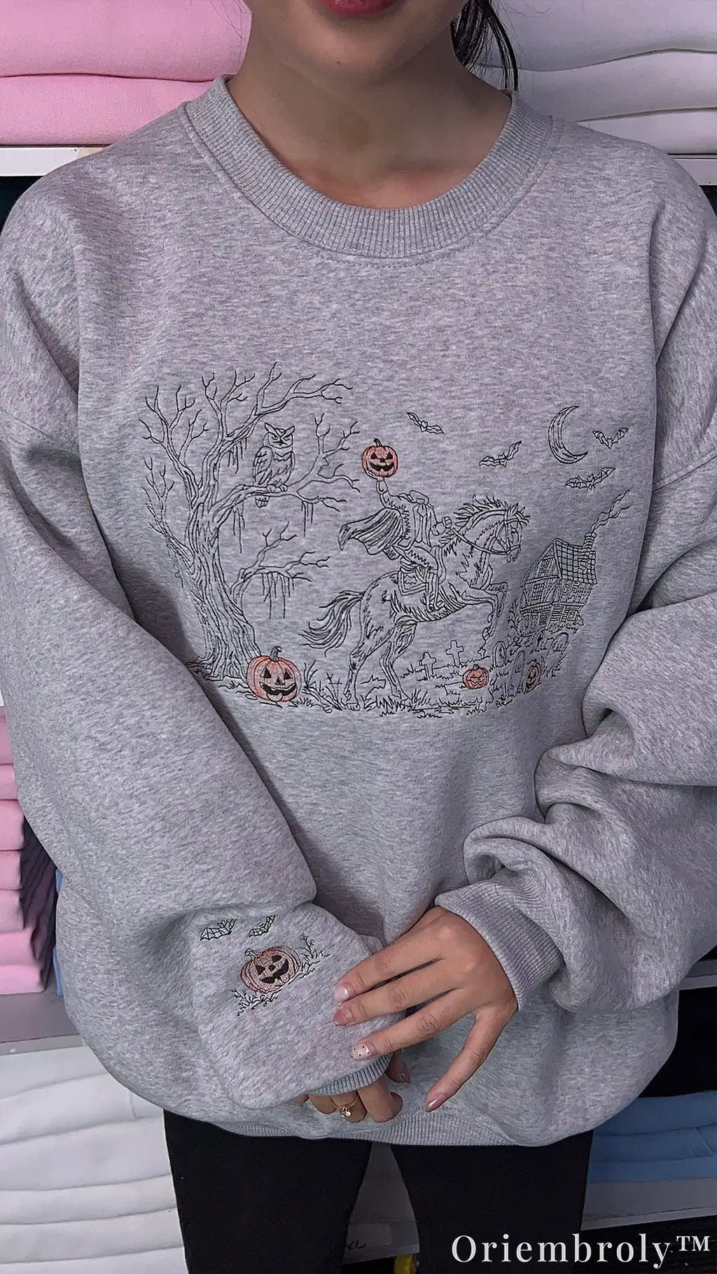 Embroidered jack-o'-lantern and bats on sweatshirt sleeve