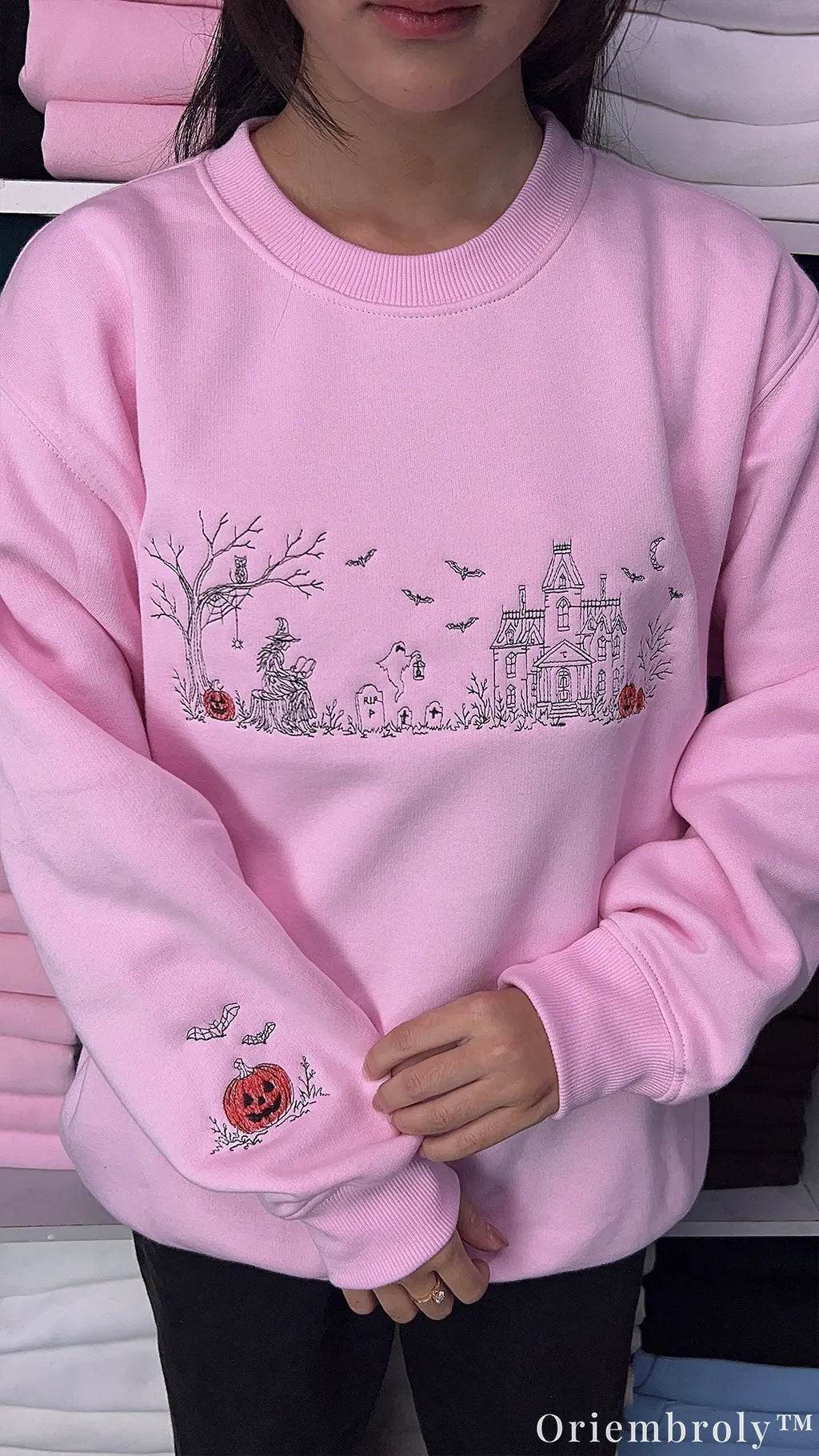 Vintage-inspired spooky village embroidered sweatshirt with model wearing
