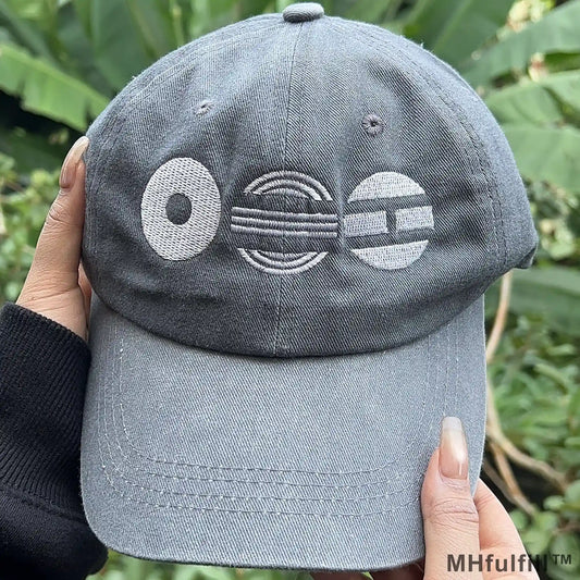 Gen Z model wearing the limited edition geometric symbols embroidered hat in a casual urban setting.