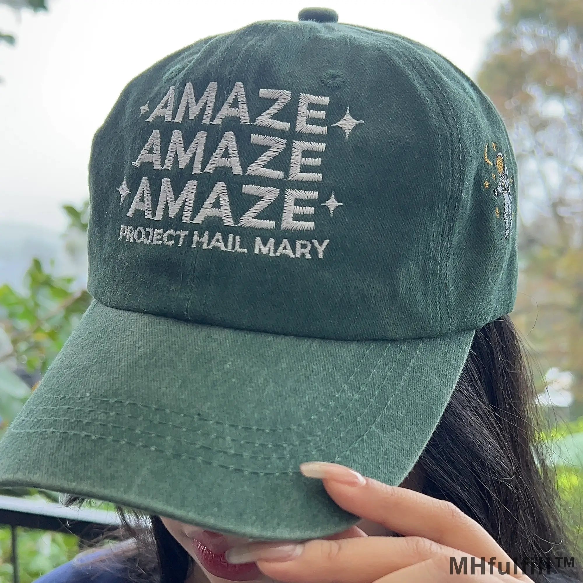 Front view of the MHfulfill vintage washed green embroidered cap featuring white text typography that reads Amaze Amaze Amaze Project Hail Mary with star accents.